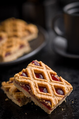 Sweet linzer cake on black table.