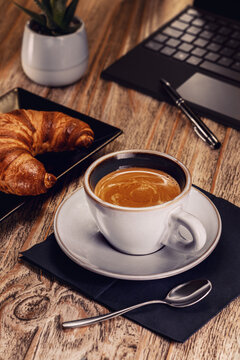 Coffee Break with Croissant and Laptop