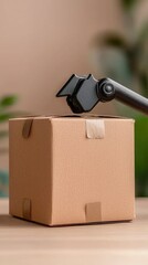 A small cardboard box being processed by a mechanical device