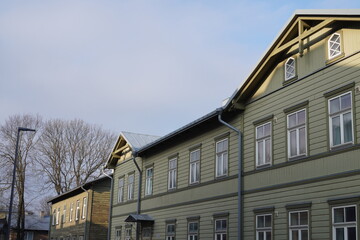 Historic wooden buildings in a tranquil setting with a cloudy sky during early morning in a small town