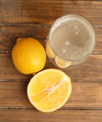 glass of lemon water and lemons