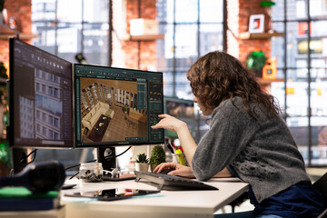 Designer interacts with digital technology to produce a virtual home set. The architectural...