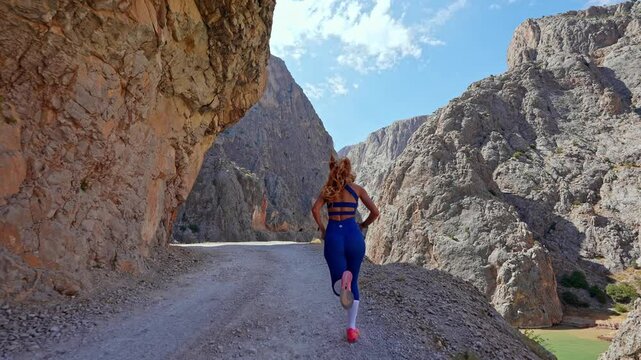 Determined Female Runner Finishing Strong in Canyon
