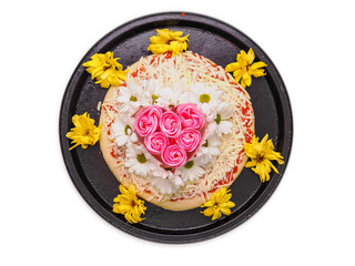 Pink roses in heart love shape and white chamomile flowers on top of a pizza and on dark metal...