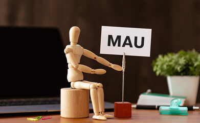 There is wood block with the word MAU. It is an abbreviation for Monthly Active Users as...