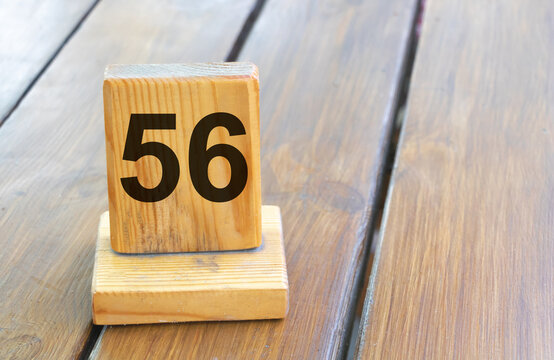 Wooden priority number 56 on a plank tab