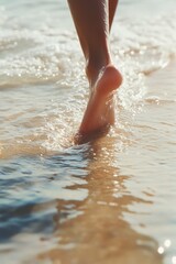 Obraz premium Barefoot stroll on wet sandy beach at sunset for tranquil summer relaxation