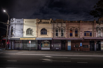 Urban scene with old terrace house and closed store front