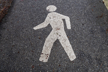 Pedestrian Walkway Symbol Painted on Asphalt Pathway for Safety Guidance