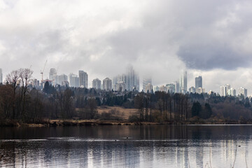 Foggy City Skyline Viewed from Deer Lake, Vancouver, BC, Canada