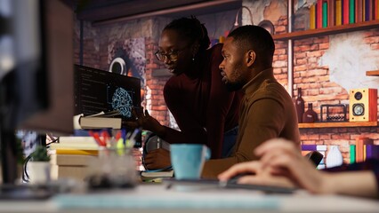 Startup staff members gathered together to conduct code review to fix bugs, identifying technical issues. Artificial intelligence company coworkers doing brainstorming, optimizing code, camera B
