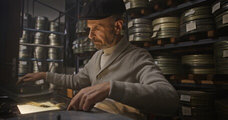 A Vintage Film Archivist Carefully Organizing the Classic Movie Reels for Preservation