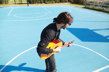 Young Believer Plays Classical Guitar Outdoors Before Mass