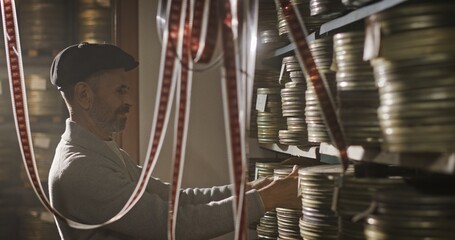 Film Archive Specialist Organizing and Preserving Vintage Film Reels for Future Generations