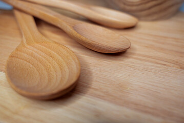 Wooden kitchen utensils on a rustic wooden surface