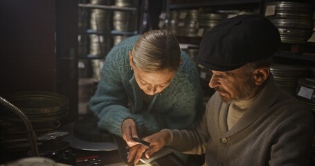 An Elderly Couple Collaborating and Working Together on Vintage Film Reels with Love and Passion
