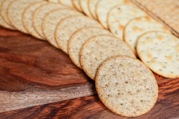 Assorted Whole Grain and Herb Crackers on a Wooden Cutting Board