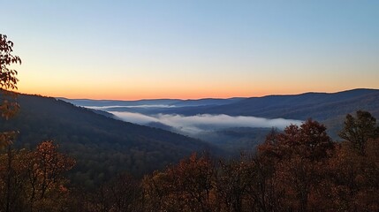 A peaceful sunrise over the mountains with mist in the