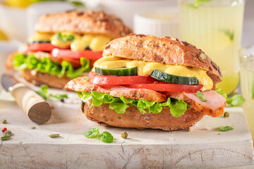 Fresh sandwich with curry chicken, lettuce and tomato.