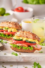 Tasty sandwich served with lemonade in summer.