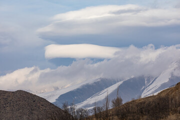 Lenticular clouds weather phenomenon over the landscapes of Syunik (Zangezur), Armenia. These...