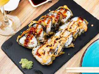 Tasty hasaki maki set served on black stone tray