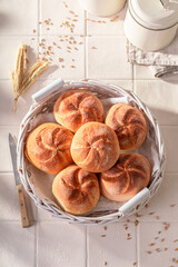 Hot and homemade crispy kaiser buns in rustic bakehouse.