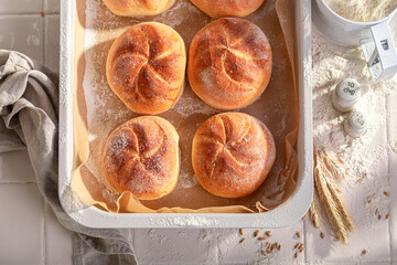 Healthy and tasty crispy kaiser buns in rustic bakehouse.