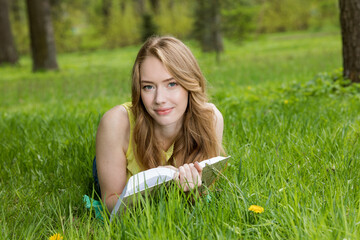 young woman in green park on grass