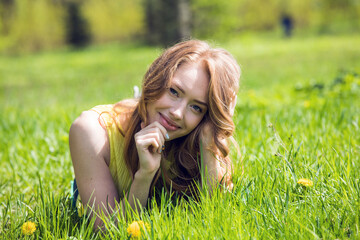 young woman in green park on grass