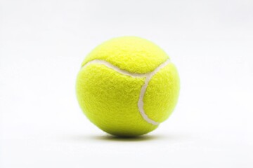 Bright yellow tennis ball on clean white background indoors