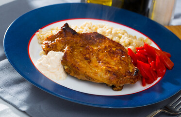 Plate of tasty roasted beef steak with barley porridge and roasted pepper