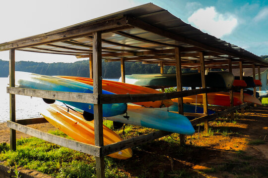Colorful Assortment of Canoes in a Boat Rack, Near Lake