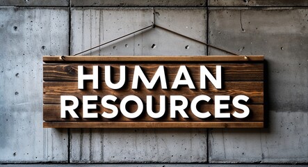Obraz premium human resources lettering on wooden sign board hanging on concrete wall background