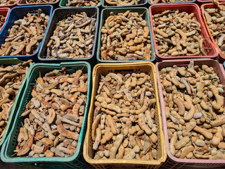 Ripe tamarinds in plastic boxes ready to sell