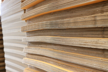 Paper factory process texture carton industry brown cardbox. container cardboard for packing, Pile of corrugated cardboard sheets and ready to use. Paper card box manufacture, raw materials industry.