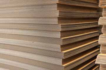 Paper factory process texture carton industry brown cardbox. container cardboard for packing, Pile of corrugated cardboard sheets and ready to use. Paper card box manufacture, raw materials industry.