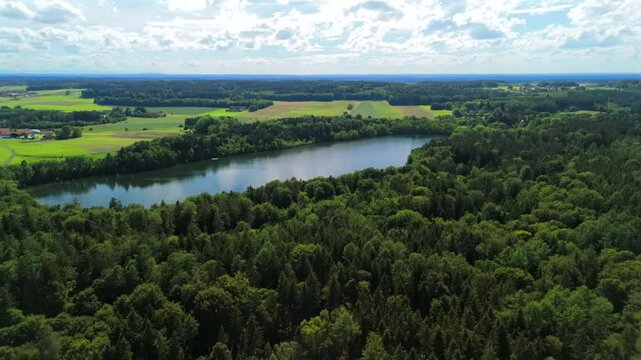 Steinsee bei Munchen Luftaufnahme. Steinsee, See in Bayern Luftbildansicht. Lake Stein aerial view near Munich, Bavaria, Germany. One of warmest lakes in Germany. Steinsee is located in forest area. 