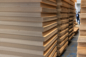 Paper factory process texture carton industry brown cardbox. container cardboard for packing, Pile of corrugated cardboard sheets and ready to use. Paper card box manufacture, raw materials industry.