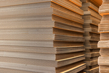 Paper factory process texture carton industry brown cardbox. container cardboard for packing, Pile of corrugated cardboard sheets and ready to use. Paper card box manufacture, raw materials industry.