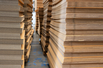 Paper factory process texture carton industry brown cardbox. container cardboard for packing, Pile of corrugated cardboard sheets and ready to use. Paper card box manufacture, raw materials industry.