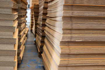 Paper factory process texture carton industry brown cardbox. container cardboard for packing, Pile of corrugated cardboard sheets and ready to use. Paper card box manufacture, raw materials industry.