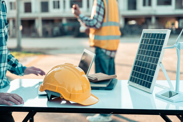 Close-up of industrial engineers team meeting to analyze machinery plans, discuss architectural projects, review construction plans and building plans using tablets at conference table.