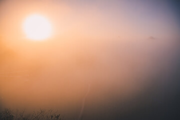 Rapeseed flowers of Luoping in Yunnan China from the top in a dense fog during the sunrise