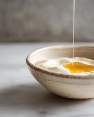 Fresh Greek Yogurt with Honey Drizzle in Artisanal Ceramic Bowl on Marble Surface
