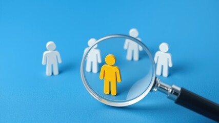 Magnifying Glass Focusing on One Person Among White Figures