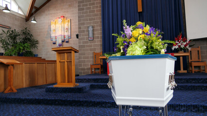 closeup shot of a grand funeral casket or coffin in a chapel or church
