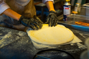 Making process of pizza stella napoletana, a traditional star-shaped pizza from Naples or Napoli,...