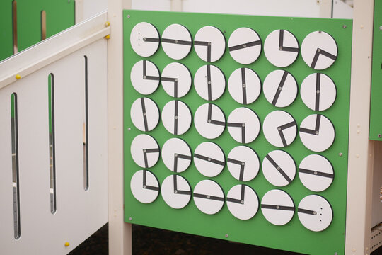 Children engage with interactive clock display in playground