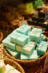 Colorful handmade soap displayed in a local market basket
